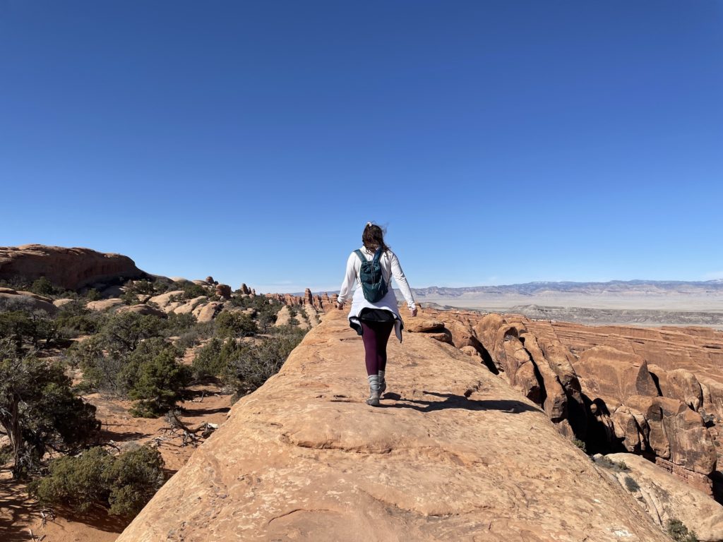 woman hiking at Arches National Park